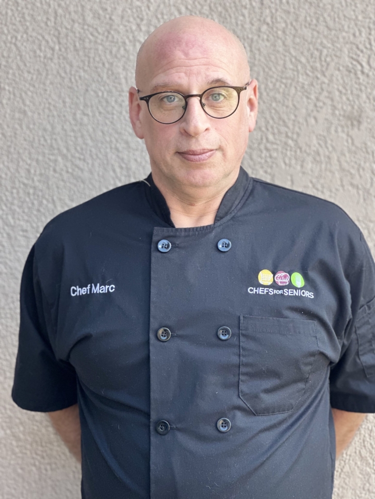 Head shot of Marc Clermont, owner of Chefs for Seniors of Spring Hill Florida wearing chef coat