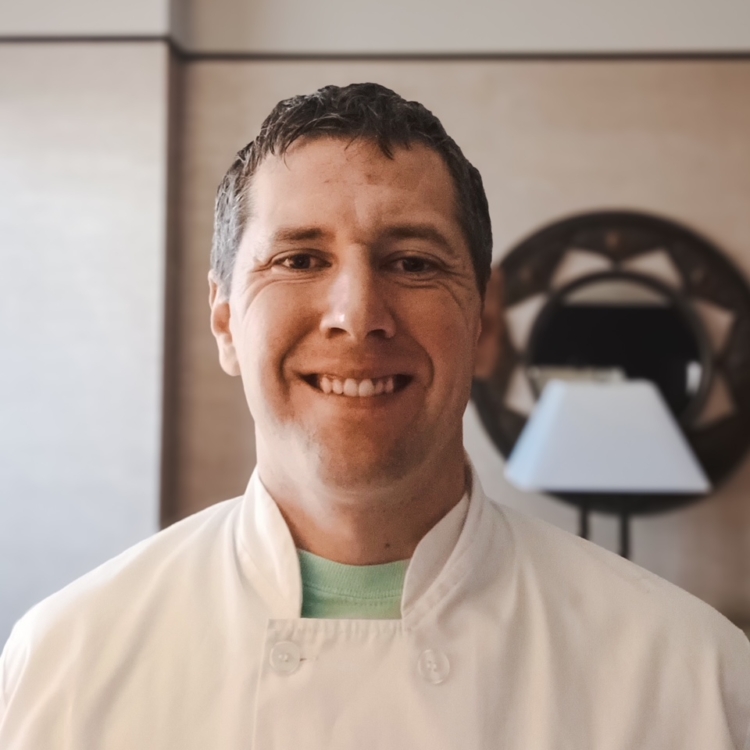 Chefs for Seniors Green Valley local owner Ben Dezso headshot in white chef coat