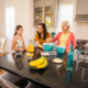Woman and daughter stand with grandmother at a kitchen island as they cook together